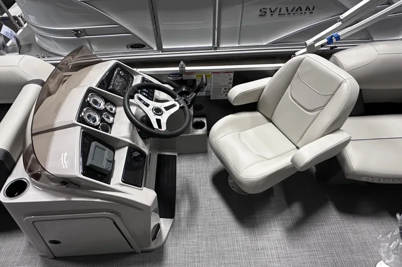 Slide: The Image of 2026 Sylvan Mirage 820 LZ boat interior with steering console and captain's chair. - 12