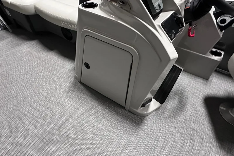 Slide: The Image of Interior of 2026 Sylvan Mirage 820 LZ boat, featuring console and seating area. - 14