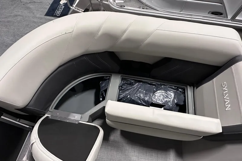 Slide: The Image of Interior seating of 2026 Sylvan Mirage 820 LZ boat with storage compartment open. - 17
