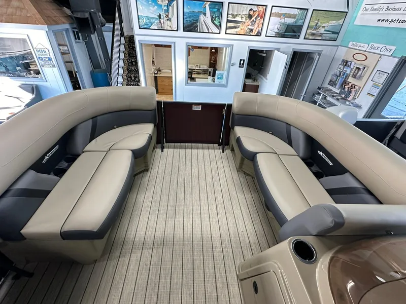 Slide: The Image of 2025 Sylvan Mirage X1 boat dashboard with steering wheel and controls. - 12