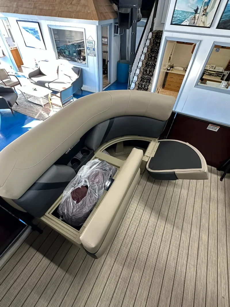 Slide: The Image of 2025 Sylvan Mirage X1 boat interior with beige seating and modern design. - 13