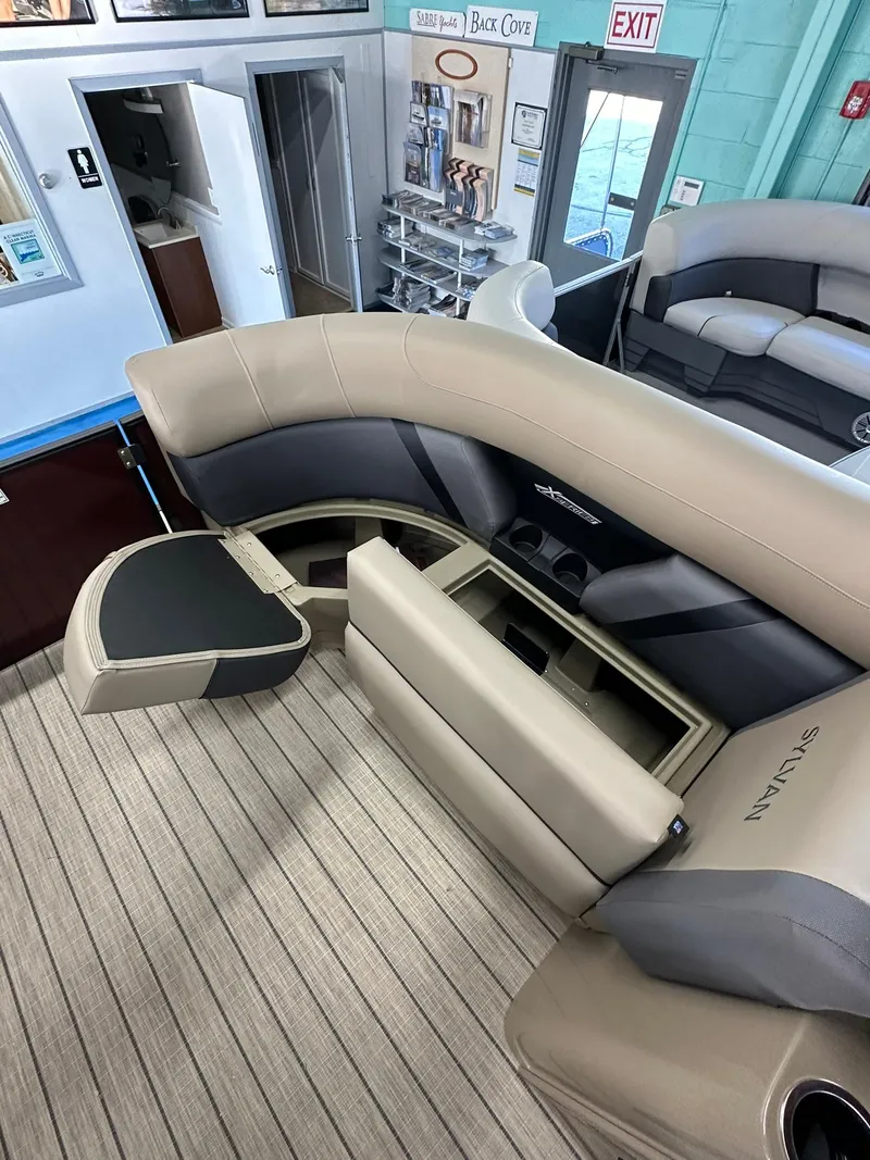 Slide: The Image of 2025 Sylvan Mirage X1 boat interior with open storage compartment and seating. - 14