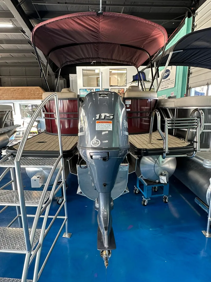 Slide: The Image of 2025 Sylvan Mirage X1 pontoon boat with canopy on display in showroom. - 4