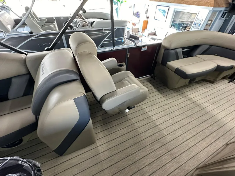 Slide: The Image of 2025 Sylvan Mirage X1 boat interior with luxurious seating and modern dashboard. - 9