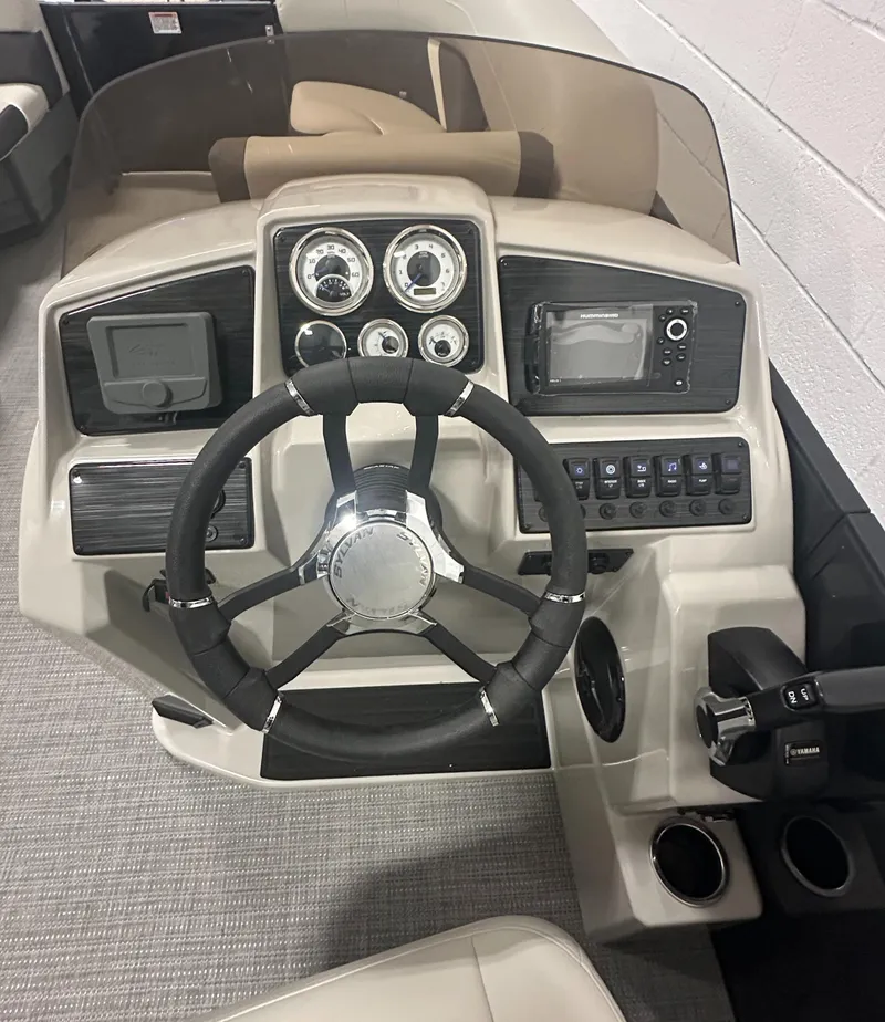 Slide: The Image of 2025 Sylvan Mirage X3 CLZ DH boat cockpit with steering wheel and captain's chair. - 16