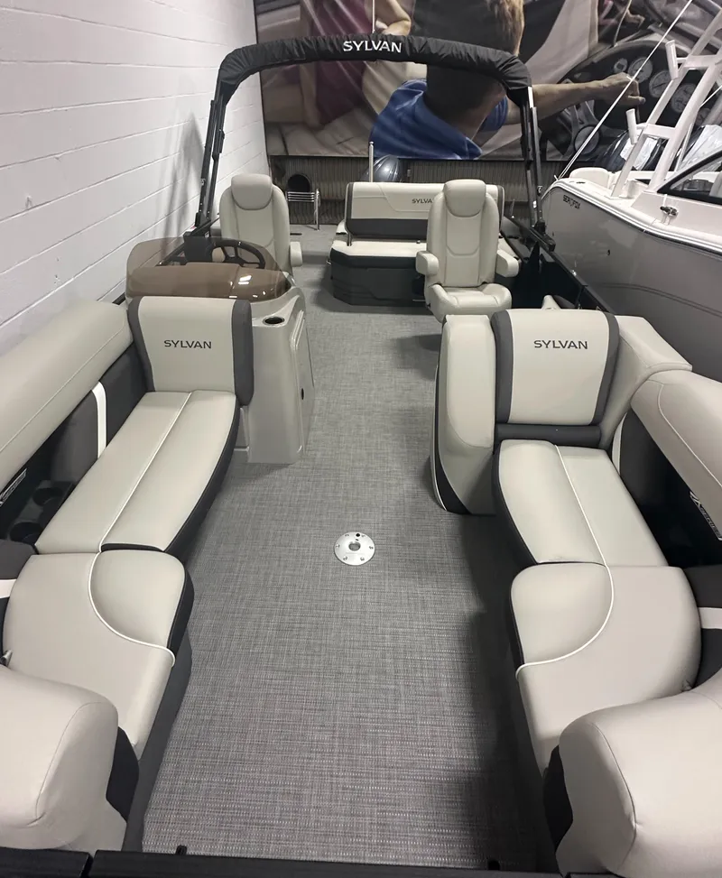 Slide: The Image of 2025 Sylvan Mirage X3 CLZ DH boat interior with beige seating and storage compartment. - 23