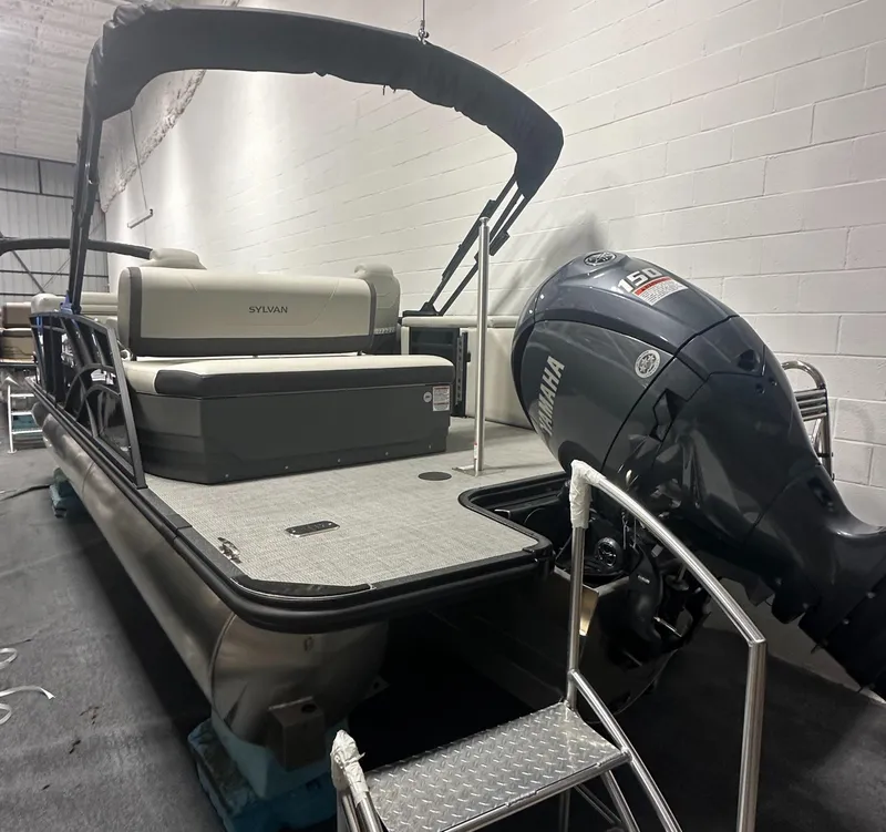 Slide: The Image of 2025 Sylvan Mirage X3 CLZ DH pontoon boat with Yamaha outboard in a showroom. - 3
