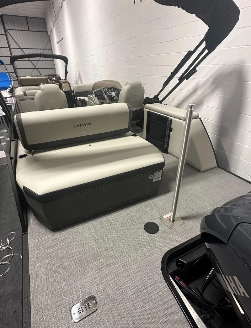 Slide: The Image of 2025 Sylvan Mirage X3 CLZ DH pontoon boat with Yamaha outboard motor in a garage. - 4