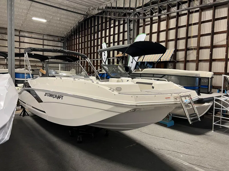 Slide: The Image of 2024 Starcraft SVX 210 OB boat in indoor storage facility. - 2