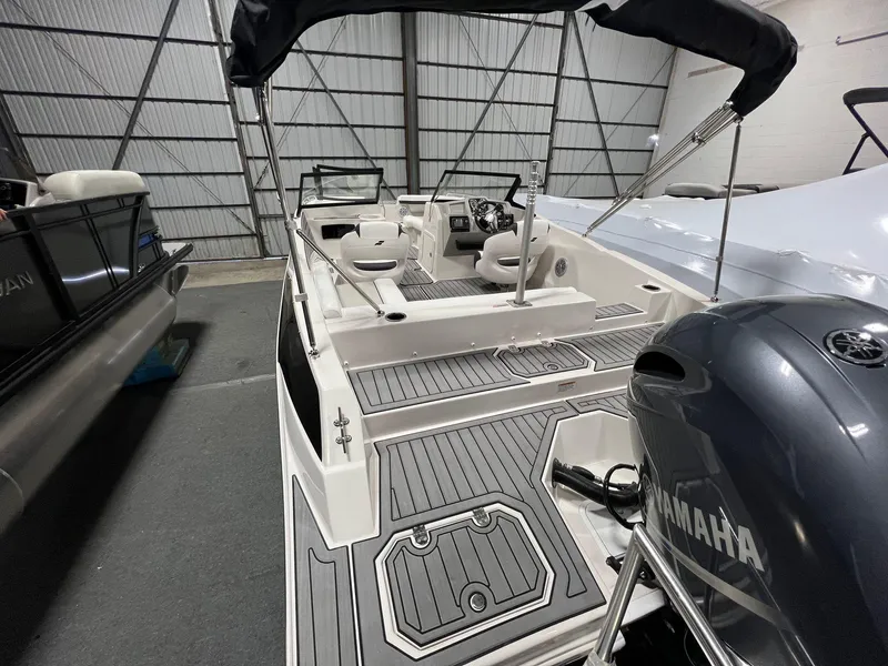 Slide: The Image of 2024 Starcraft SVX 210 OB boat with Yamaha outboard motor in a showroom. - 4