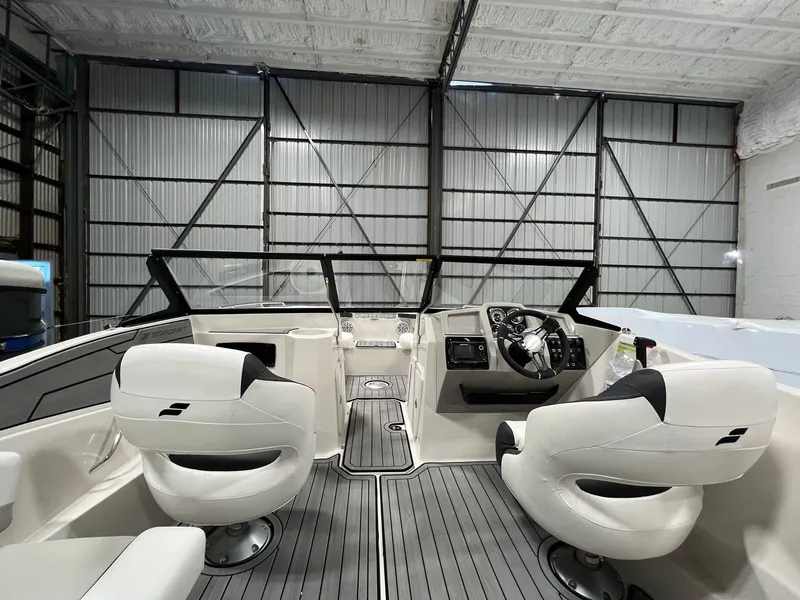 Slide: The Image of 2024 Starcraft SVX 210 OB boat interior with white seats and modern dashboard. - 6
