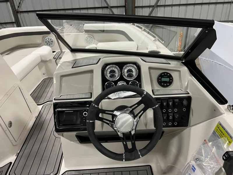 Slide: The Image of 2024 Starcraft SVX 210 OB boat dashboard with steering wheel and control panel. - 9