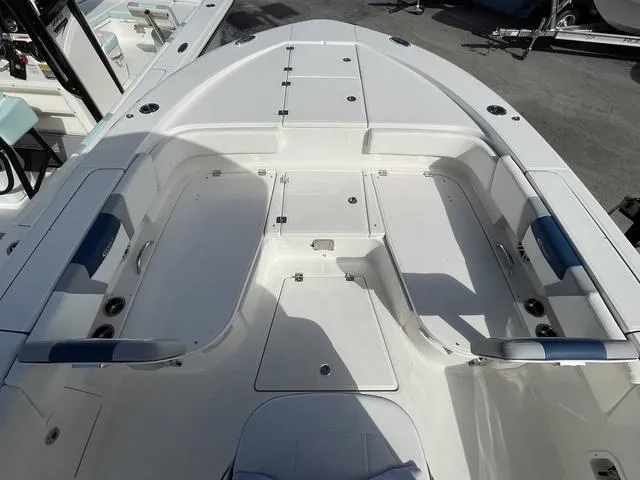 Slide: The Image of 2023 Robalo 266 Cayman boat interior with spacious seating and storage compartments. - 16