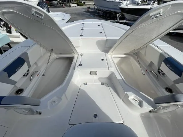 Slide: The Image of 2023 Robalo 266 Cayman boat with open storage compartments. - 17