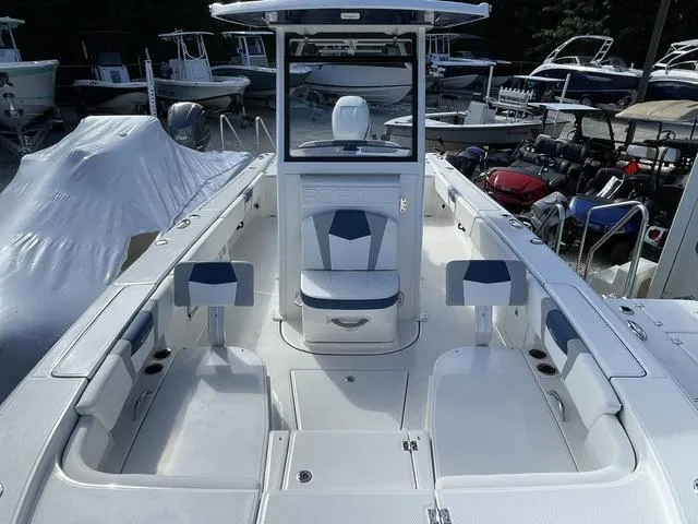 Slide: The Image of 2023 Robalo 266 Cayman boat interior with seating and storage compartments. - 19