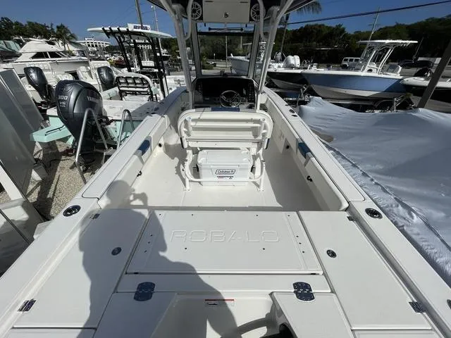 Slide: The Image of 2023 Robalo 266 Cayman boat interior, featuring spacious deck and seating. - 3