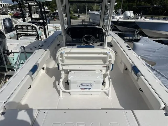 Slide: The Image of 2023 Robalo 266 Cayman boat interior with seating and Coleman cooler. - 4