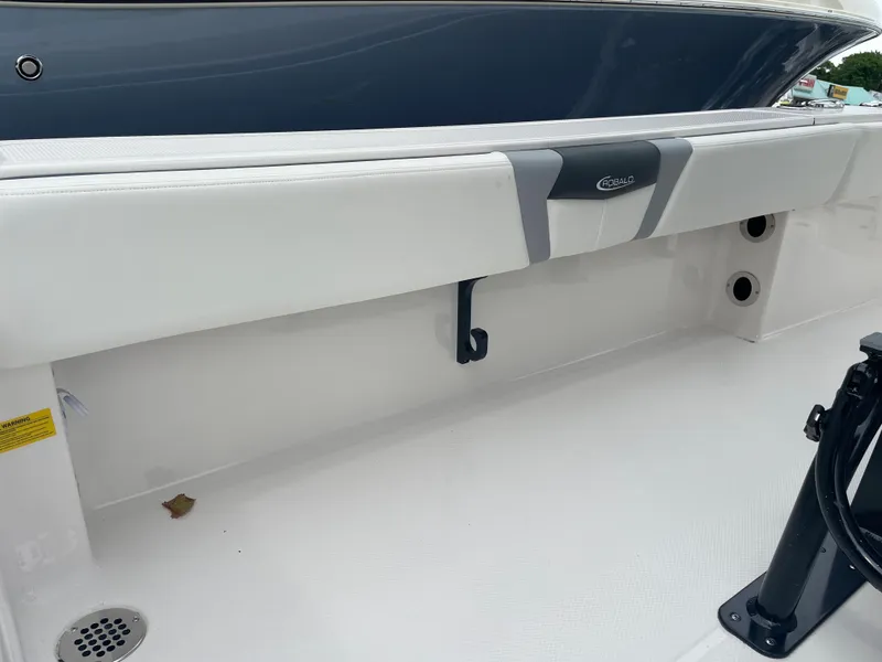 Slide: The Image of 2023 Robalo 266 Cayman boat interior, white seating and clean deck. - 11
