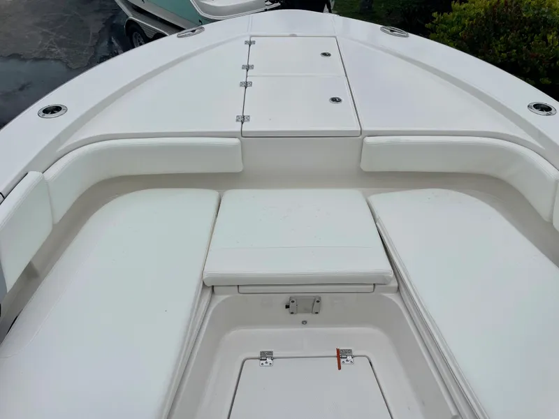 Slide: The Image of 2023 Robalo 266 Cayman boat bow seating area with storage compartments. - 16