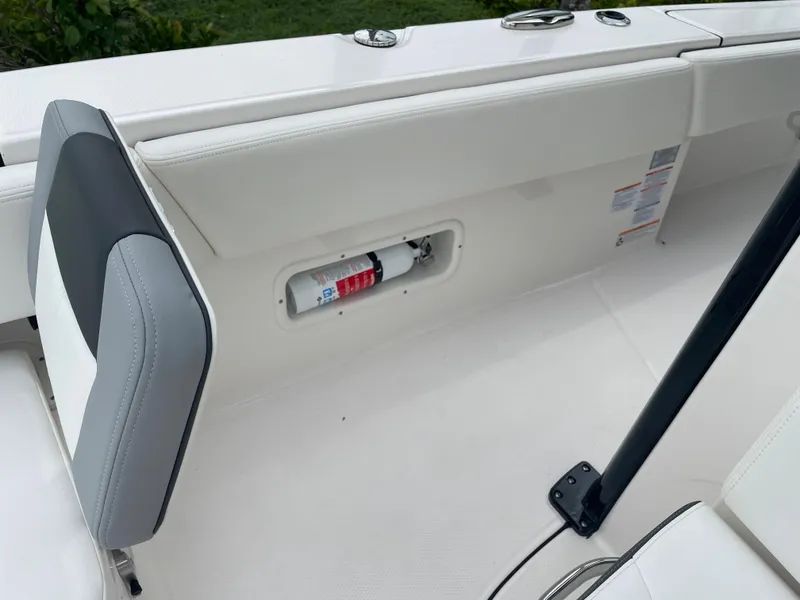 Slide: The Image of 2023 Robalo 266 Cayman boat interior with fire extinguisher compartment. - 23