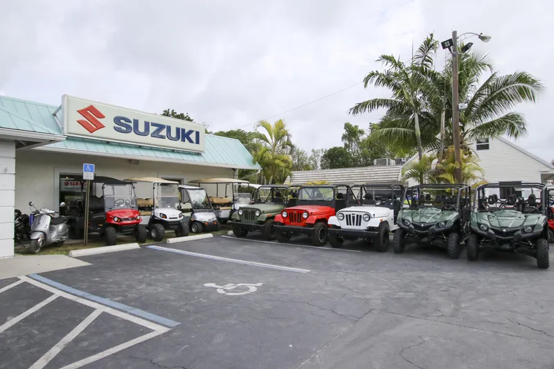 Slide: The Image of Suzuki dealership with various off-road vehicles parked outside. - 31
