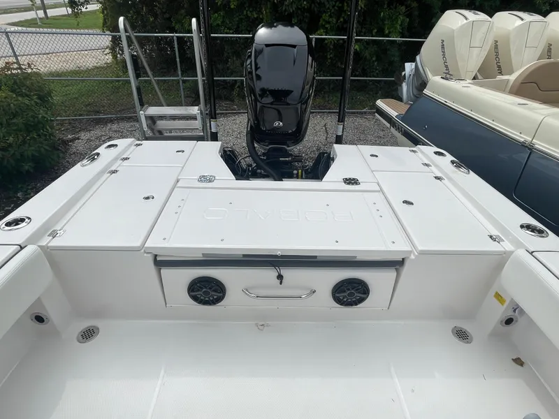 Slide: The Image of 2023 Robalo 266 Cayman boat stern with outboard motor and storage compartments. - 7