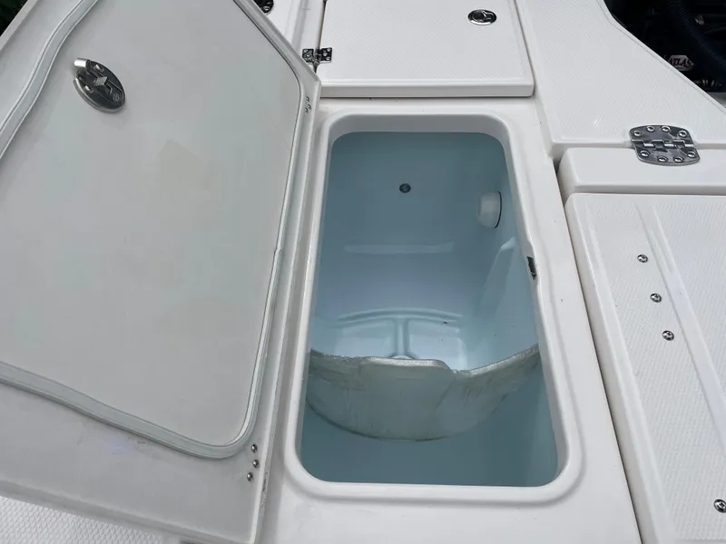 Slide: The Image of 2023 Robalo 266 Cayman boat storage compartment with open lid. - 9