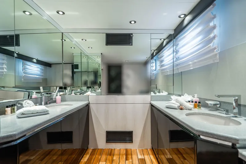 Slide: The Image of Luxurious bathroom on a 1989 Broward Tri-Deck yacht with dual sinks and modern fixtures. - 16