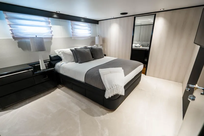 Slide: The Image of Luxurious bedroom on a 1989 Broward Tri-Deck yacht with modern decor. - 17