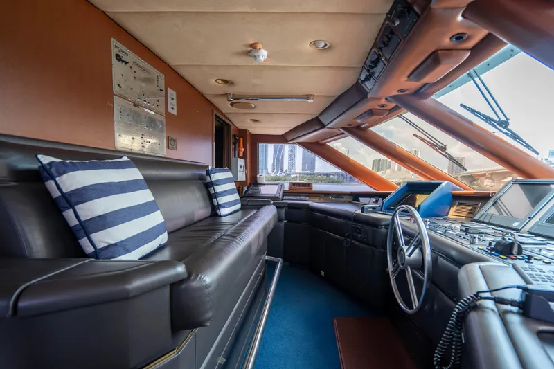 Slide: The Image of 1989 Broward Tri-Deck yacht interior with leather seating and navigation controls. - 24