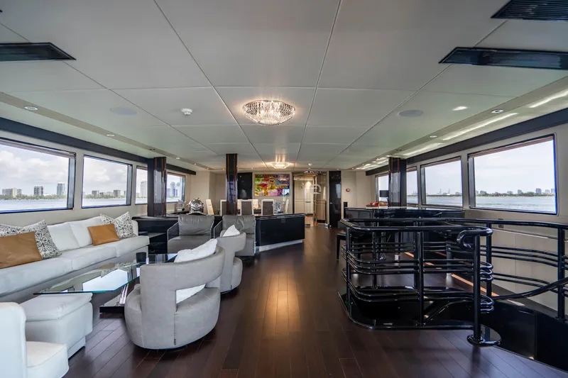 Slide: The Image of Luxurious interior of 1989 Broward Tri-Deck yacht with modern furnishings and panoramic windows. - 3