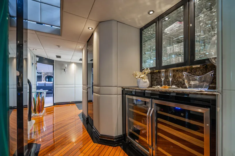 Slide: The Image of Luxurious interior of 1989 Broward Tri-Deck yacht with polished wood floors and modern bar area. - 9