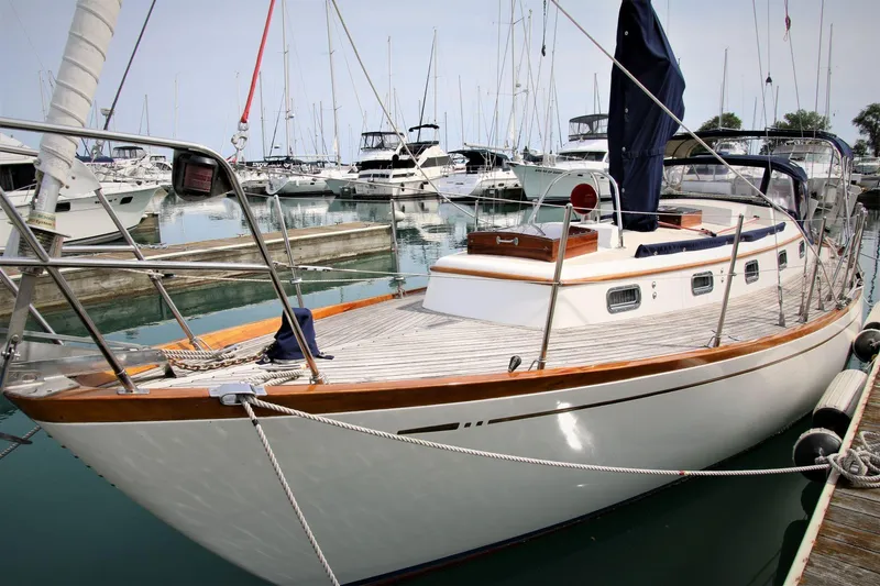 Slide: The Image of Sailboat docked in marina, Mason 33 model, 1986, surrounded by other boats. - 13