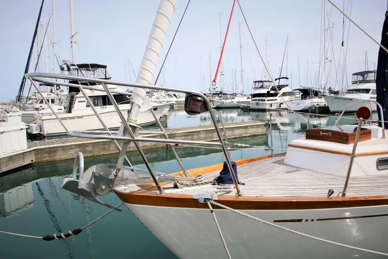 Slide: The Image of Sailboat docked in marina, Mason 33 model, 1986, surrounded by other boats. - 14