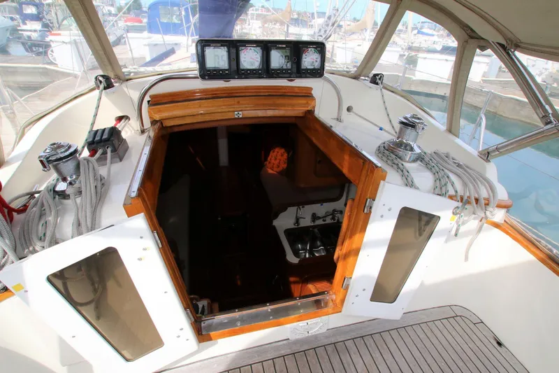 Slide: The Image of 1986 Mason 33 sailboat cockpit with navigation instruments and cabin entrance. - 20