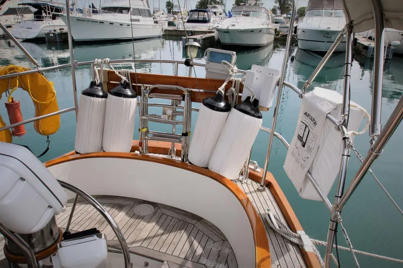 Slide: The Image of Sailboat deck view with fenders, Mason 33, 1986 model, docked in marina. - 24