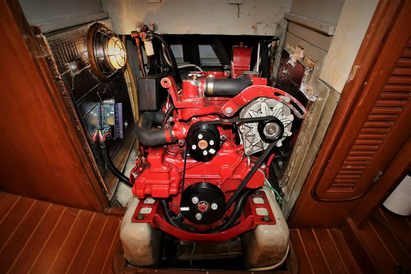 Slide: The Image of 1986 Mason 33 engine compartment with red engine and wooden flooring. - 27