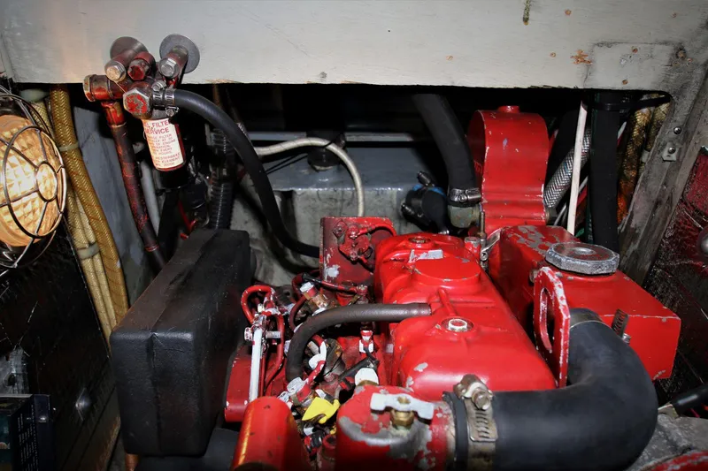 Slide: The Image of Engine compartment of a 1986 Mason 33, featuring a red engine and various components. - 28