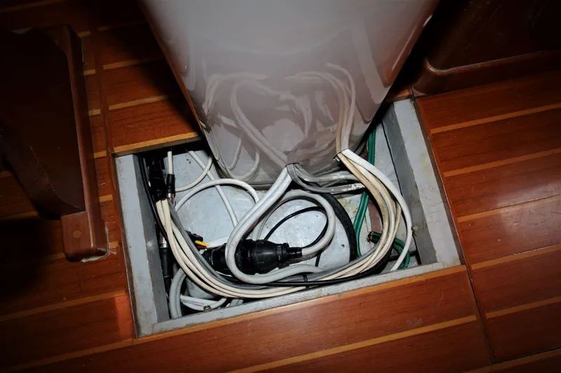 Slide: The Image of Electrical wiring inside a Mason 33 sailboat, 1986 model, with wooden flooring. - 29