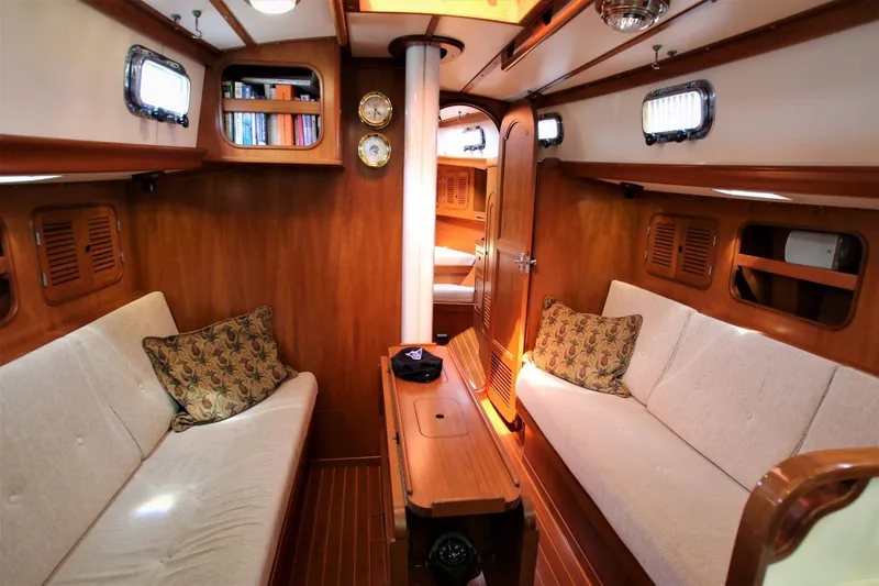 Slide: The Image of Interior of 1986 Mason 33 sailboat with cozy wooden furnishings and seating. - 3