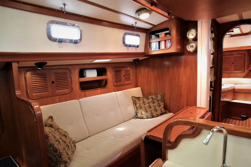 Slide: The Image of Cozy 1986 Mason 33 yacht interior with wooden finish and comfortable seating. - 34