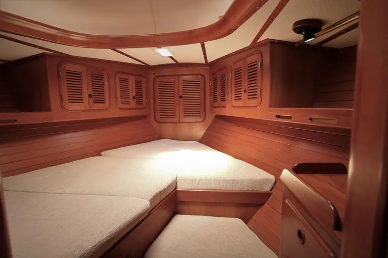 Slide: The Image of Interior cabin of 1986 Mason 33 yacht with wooden finish and cushioned seating. - 36