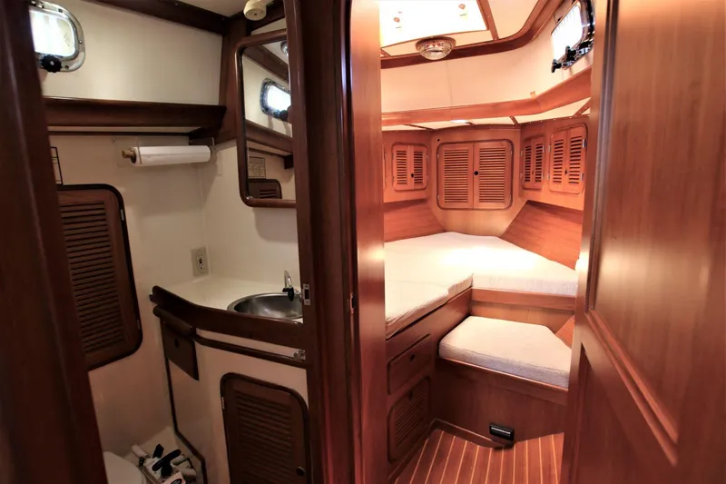 Slide: The Image of 1986 Mason 33 yacht interior with cozy cabin and compact bathroom. - 37