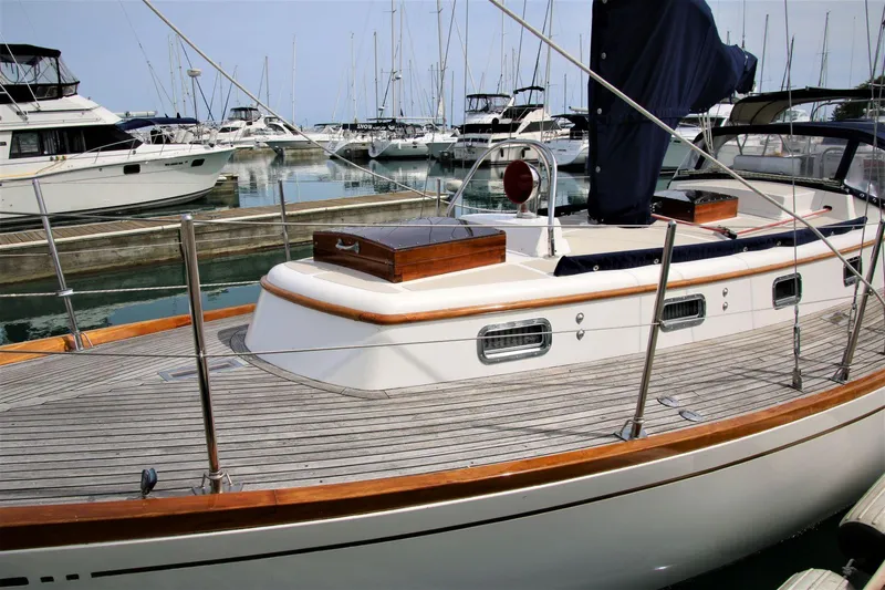 Slide: The Image of Sailboat in marina, Mason 33 model, 1986, with wooden deck and sleek design. - 8