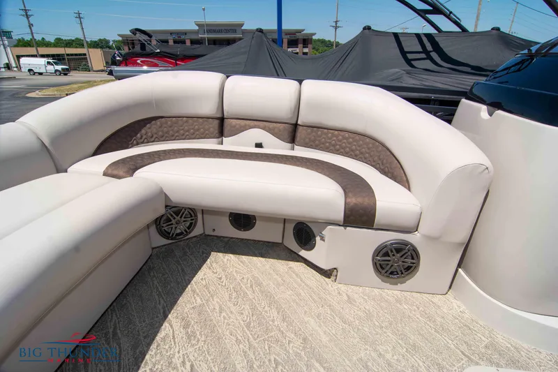 Slide: The Image of 2022 JC SunLounger 25 TT Sport boat interior with cushioned seating and built-in speakers. - 12