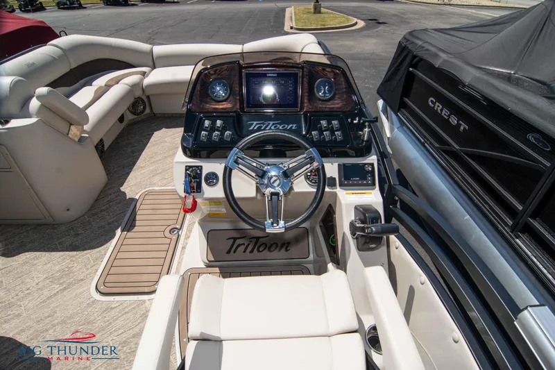 Slide: The Image of 2022 JC SunLounger 25 TT Sport boat interior with steering console and seating. - 18