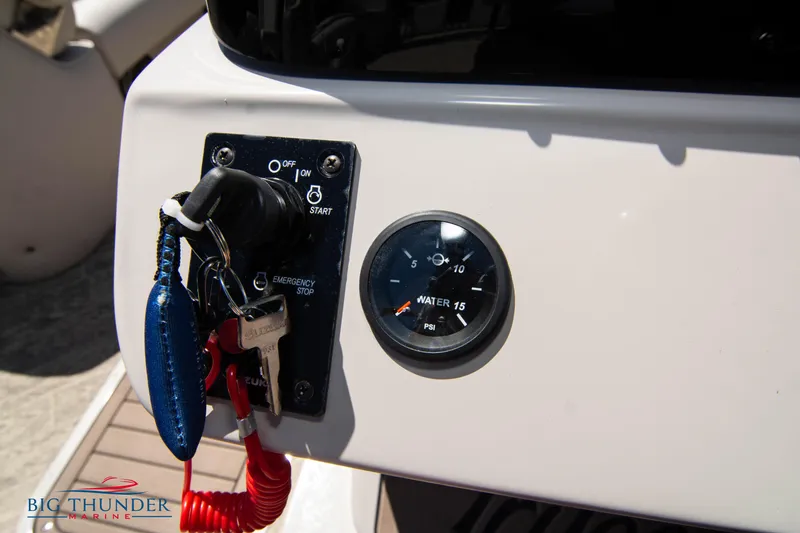 Slide: The Image of Control panel of a 2022 JC SunLounger 25 TT Sport boat with ignition and water gauge. - 26