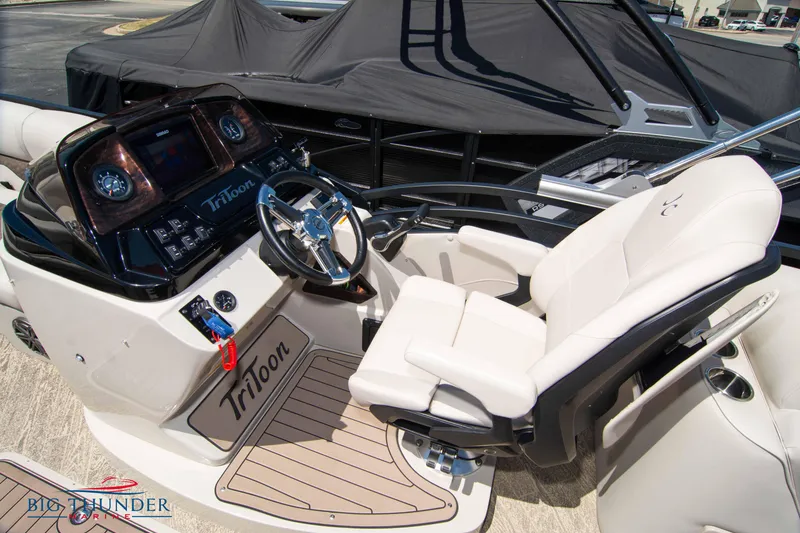 Slide: The Image of 2022 JC SunLounger 25 TT Sport boat cockpit with steering wheel and control panel. - 31