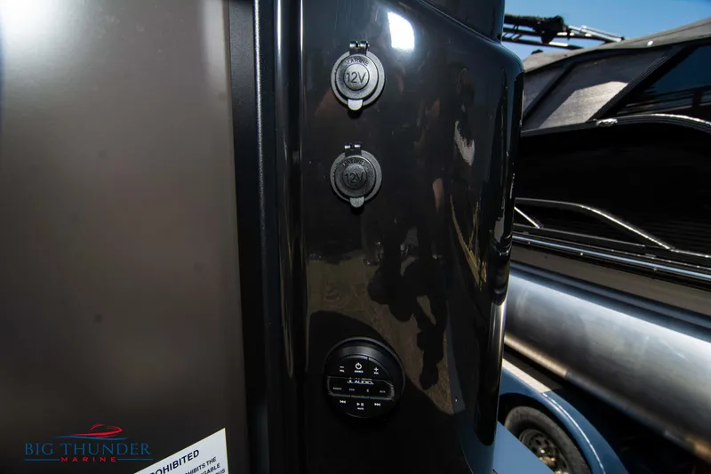 Slide: The Image of Close-up of the 2022 JC SunLounger 25 TT Sport's control panel and power outlets. - 44