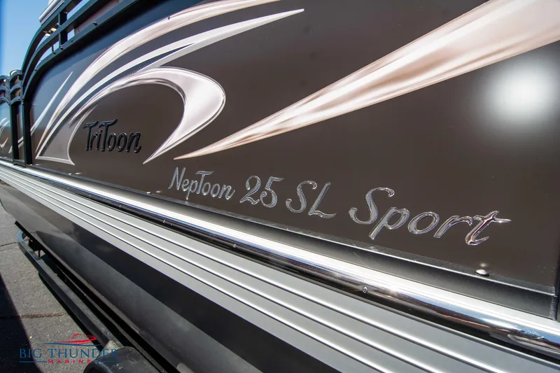 Slide: The Image of Close-up of 2022 JC SunLounger 25 TT Sport boat with sleek design and branding. - 9
